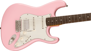 Squier FSR Classic Vibe 60's Stratocaster Electric Guitar in Shell Pink. Horizontal close-up of body with 3 control knobs on 6-string guitar
