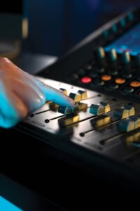 Male controlling Peavey Aureus 28 Digital Mixer in studio